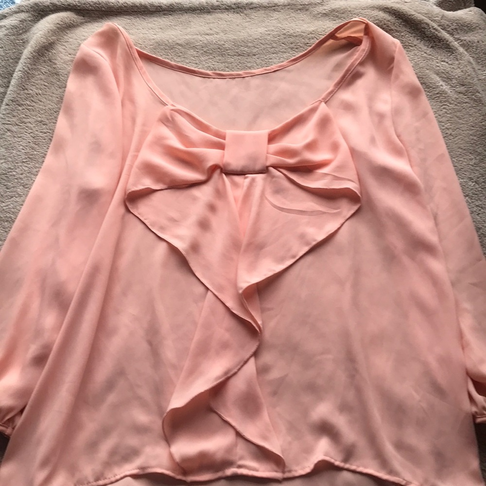 Coral colored flowy blouse, back bow detail.